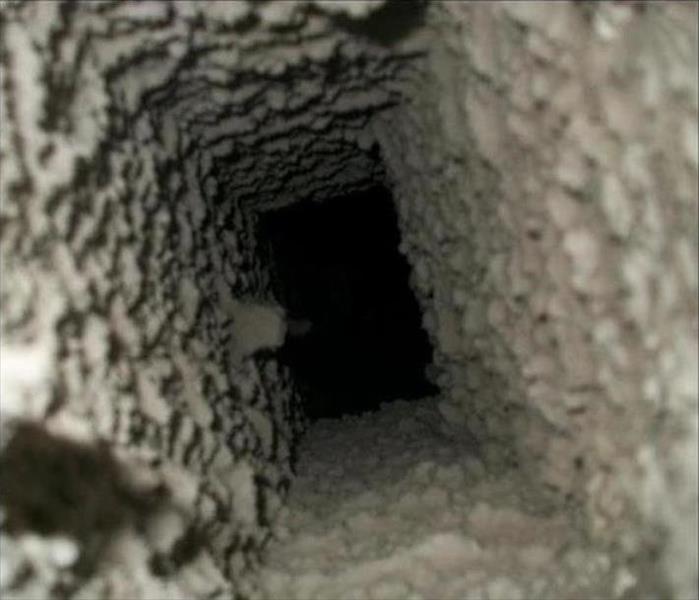 inside of an air duct covered in dust