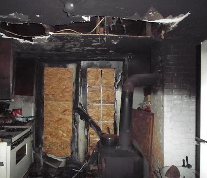 kitchen with walls and ceiling burned and covered in soot damage