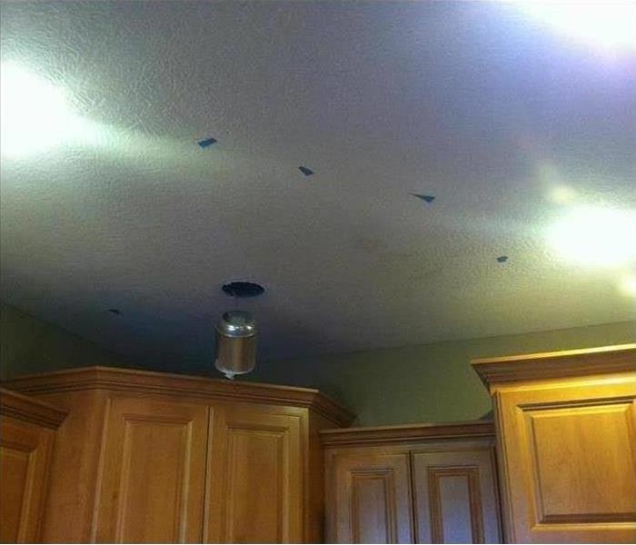 white ceiling in a kitchen with water spots