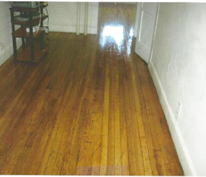 cleaned hardwood flooring in a room with white walls