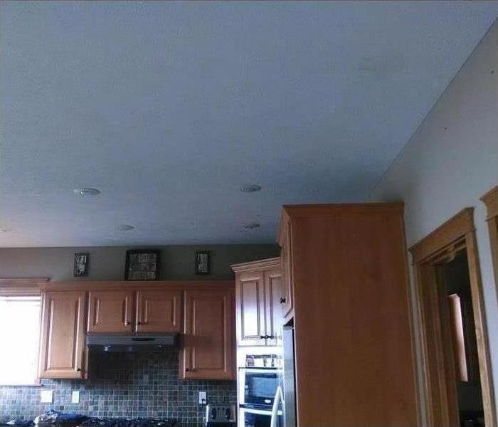 white ceiling in a kitchen with wood cabinets