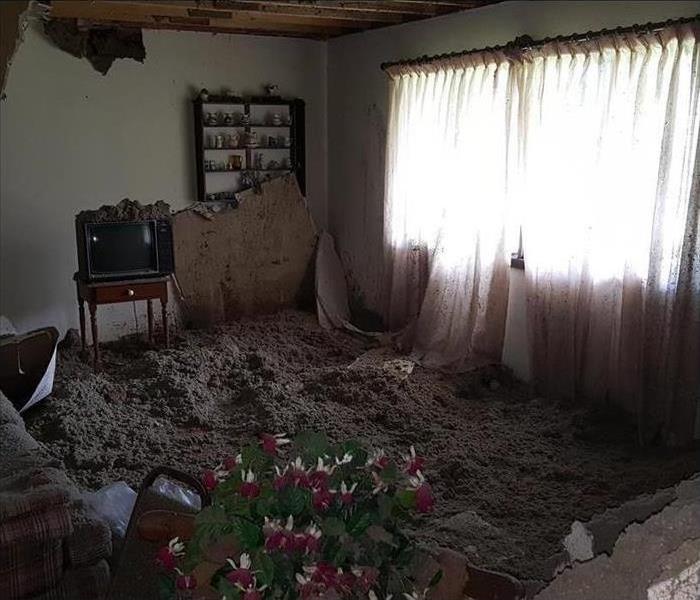 living room with the floor covered in insulation and debris
