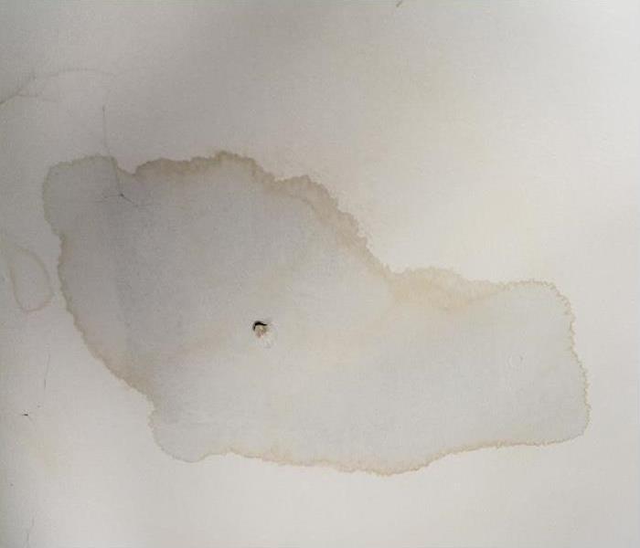 white ceiling with a large water spot