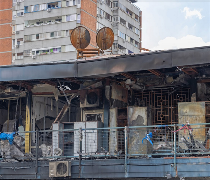 a fire damaged store with soot covering the railings and debris littering the floor