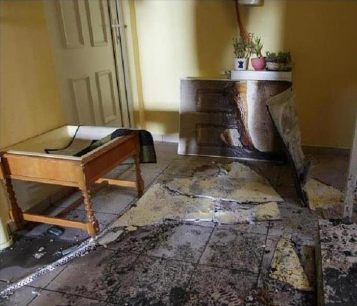 a fire damaged bedroom with debris covering the floor