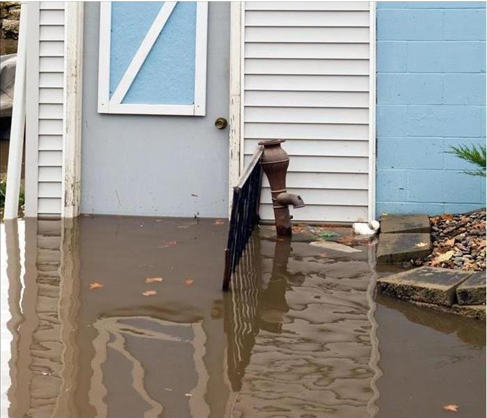 Floodwaters deepening against outside door of home